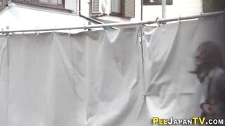 Watch this kinky Japanese babe get drenched in golden showers while peeing in public - 13 image