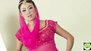 Watch this kinky Asian babe in a traditional outfit get wild with a hard dick then get her lingerie off before getting drenched in a shower - 1 image