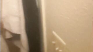 Blasian bent over bathroom sink while roommates in other room - 2 image