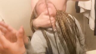 Blasian bent over bathroom sink while roommates in other room - 4 image